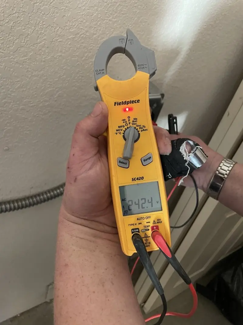 Voltage testing with clamp meter during Outlet Installation in Rock Island